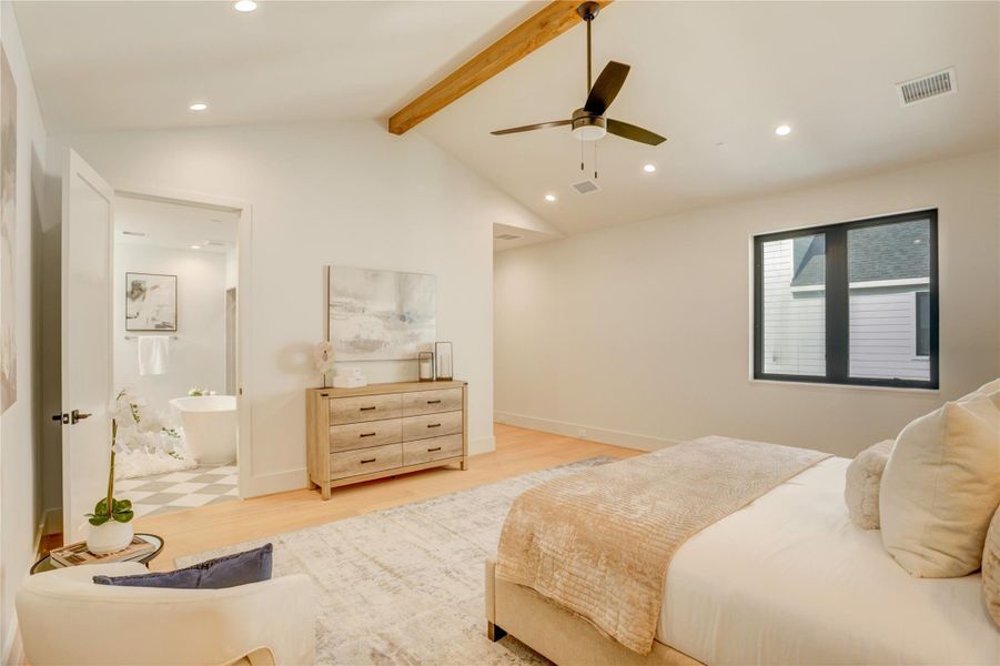 Another angle of the primary bedroom showing the orientation of the entry and bathroom.