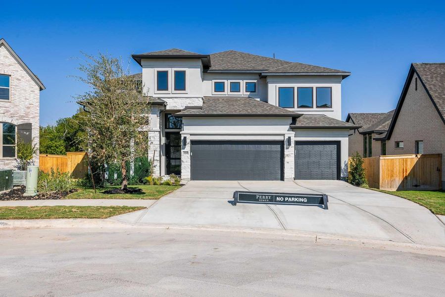 View of front facade with a garage, a shingled roof, concrete driveway, and stucco siding View of front facade with a garage, a shingled roof, concrete driveway, and stucco siding