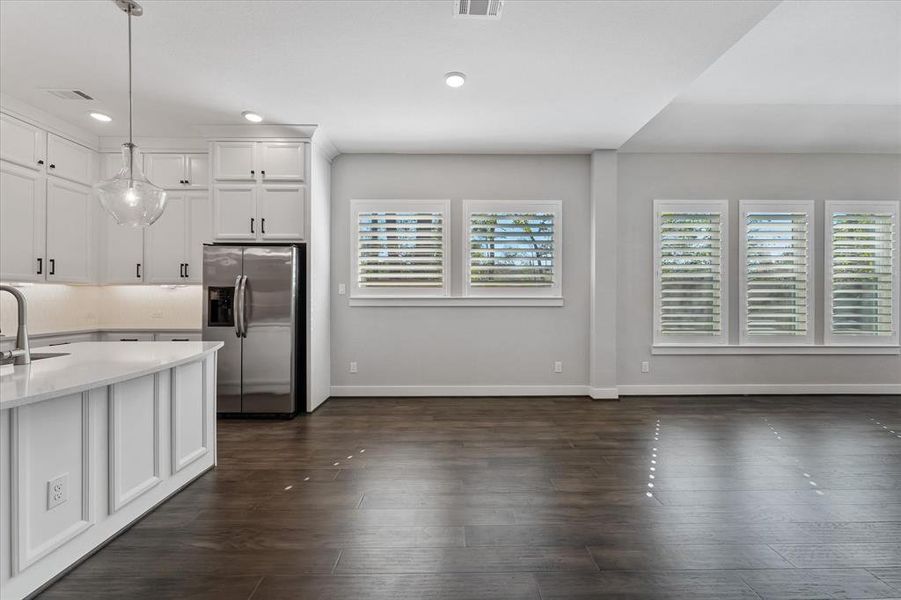 lantation shutters accent this eat in breakfast/ dining area!