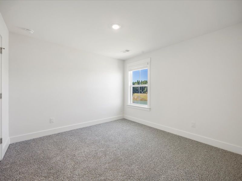 Spacious, unfurnished interior of a new home in The Coves at Lakes of Cane Bay, Summerville (Image 22).