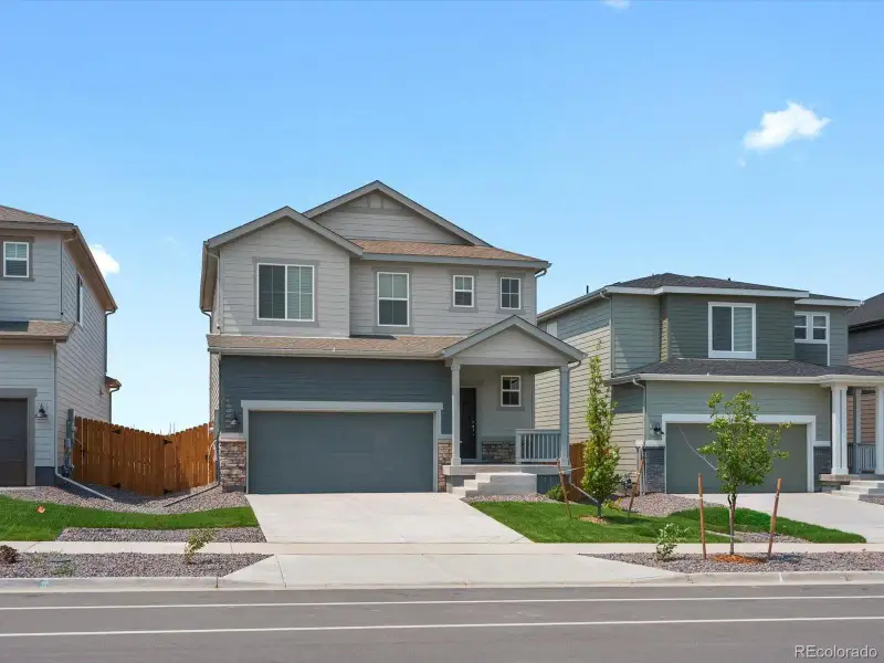 Front exterior of a new home in Lake Bluff, Greeley, CO, highlighting curb appeal (Image 1). Front exterior of a new home in Lake Bluff, Greeley, CO, highlighting curb appeal (Image 1).