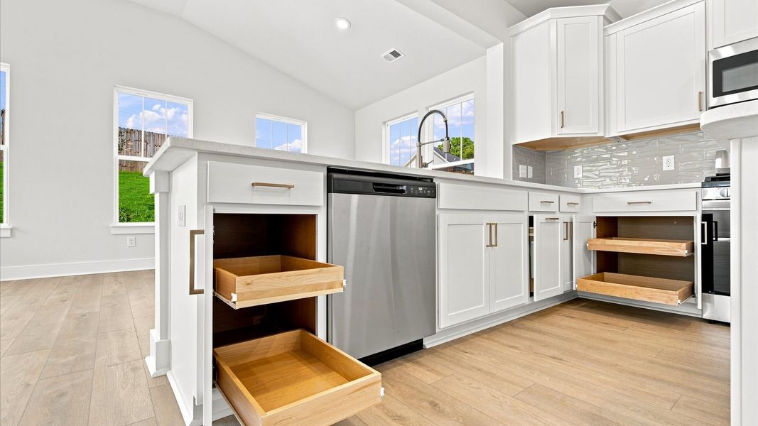 Exclusive kitchen design with large island, pendant lights, and tasteful finishes throughout