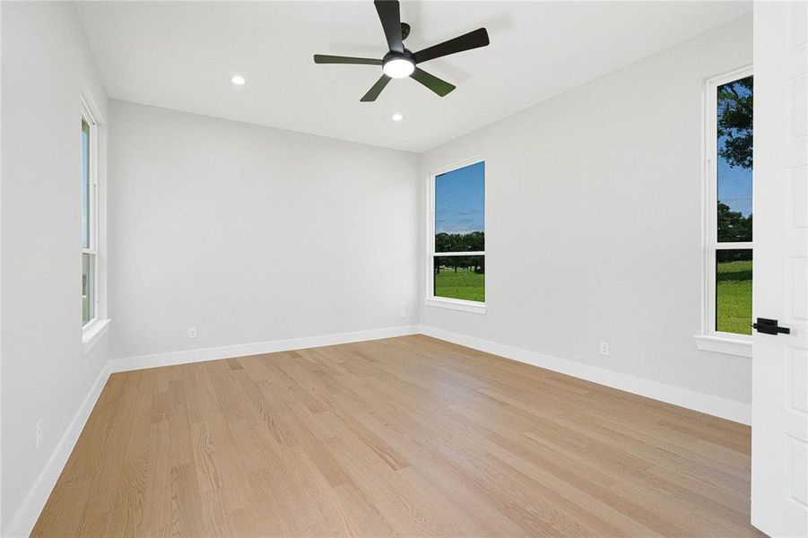 Unfurnished room featuring light wood-style flooring, ceiling fan, and recessed lighting