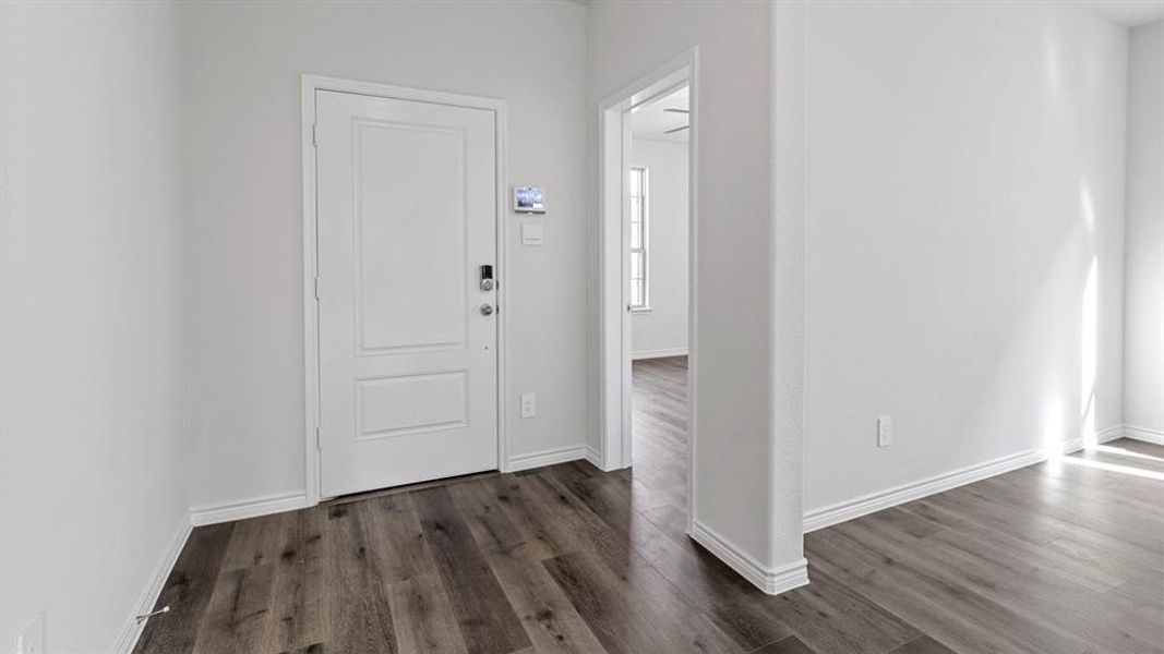 Entrance foyer featuring dark wood-type flooring
