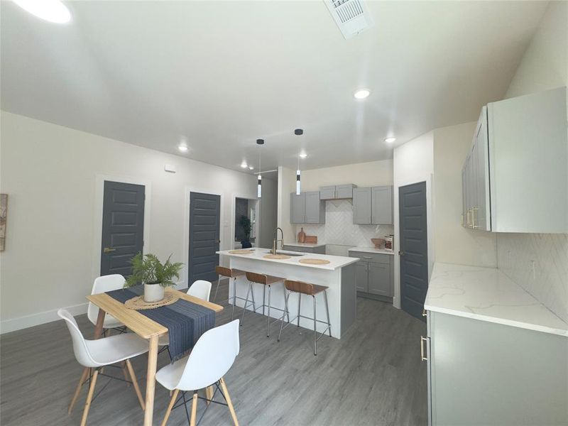 Dining space featuring sink and light wood-type flooring