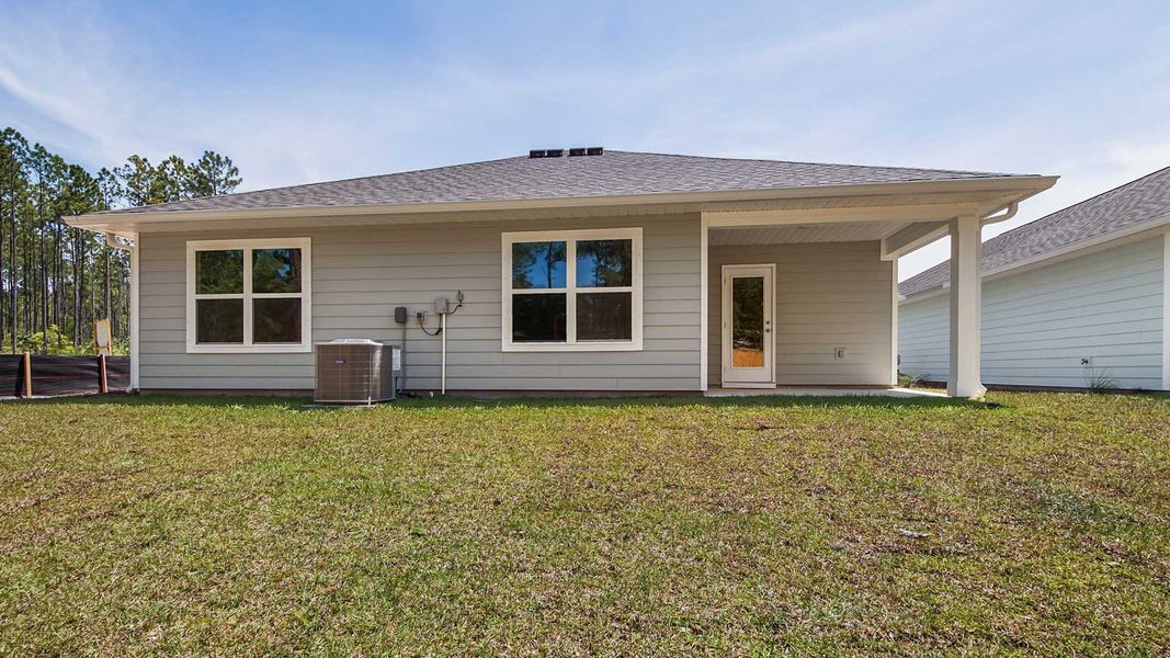 Front exterior of a new home in Ashton Park Phase III, Freeport, FL, highlighting curb appeal (Image 19).
