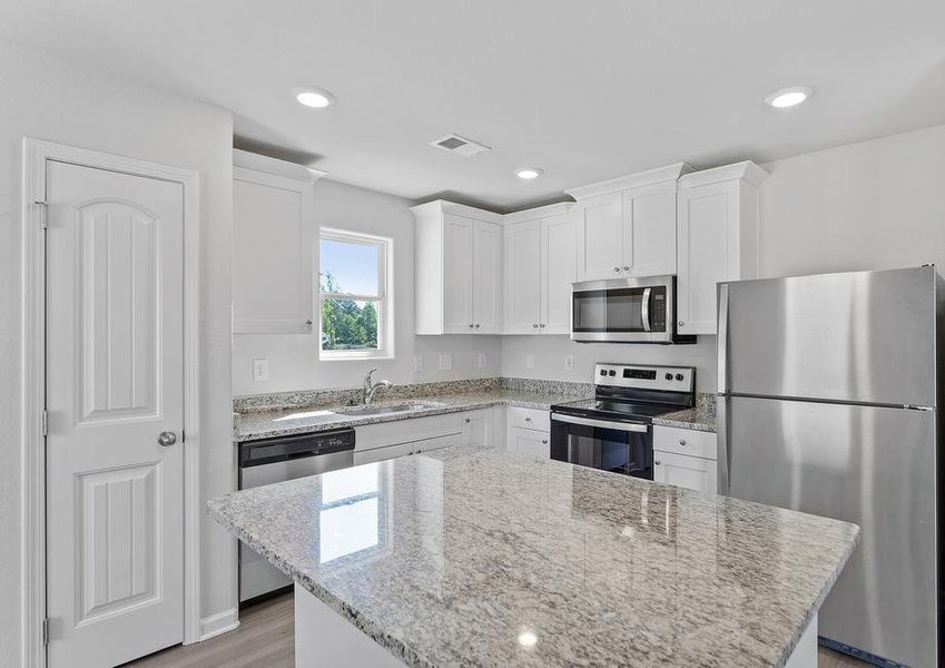 Spacious kitchen with granite countertops.