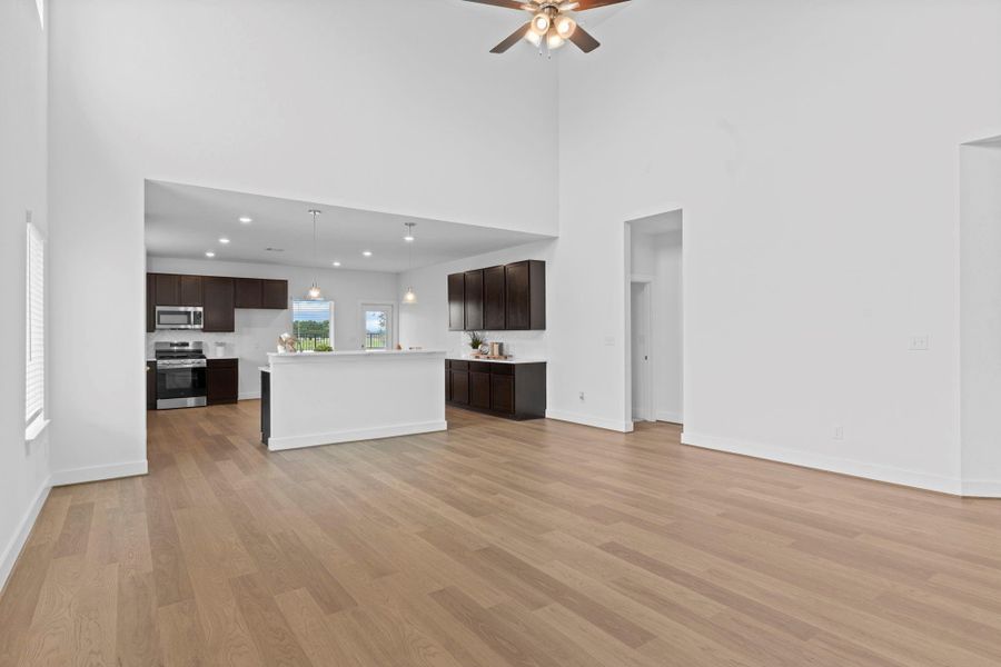 This view highlights the seamless flow from the family room into the kitchen and dining areas, with ample wall space for large furnishings or future décor. **Image Representative of Plan Only and May Vary as Built**. This view highlights the seamless flow from the family room into the kitchen and dining areas, with ample wall space for large furnishings or future décor. **Image Representative of Plan Only and May Vary as Built**.