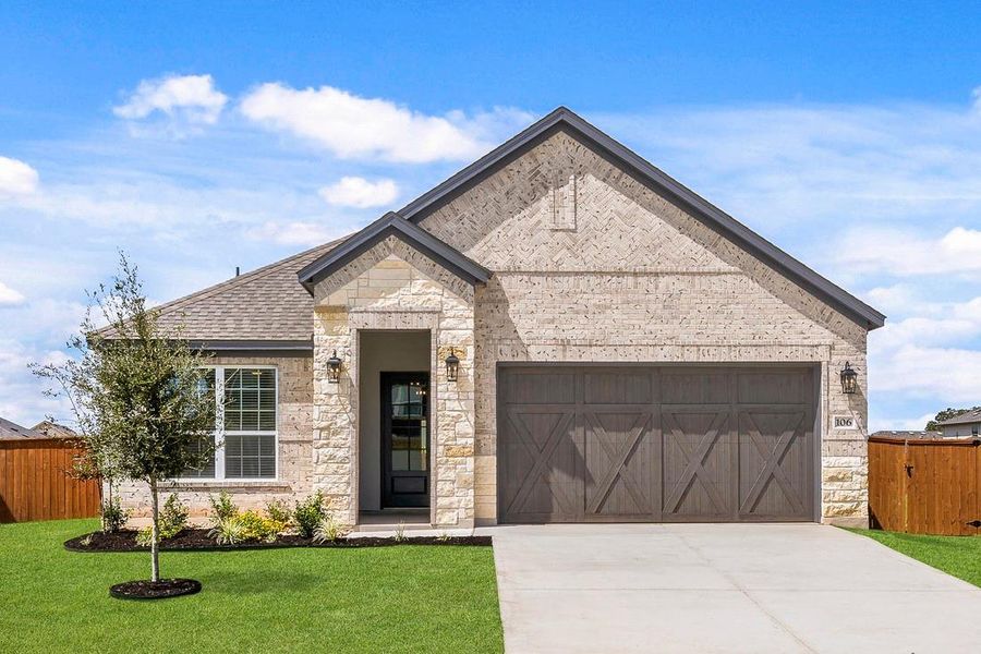 Our beautiful Kendall floor plan comes with a long driveway, a cedar garage door, and lush front yard landscaping.