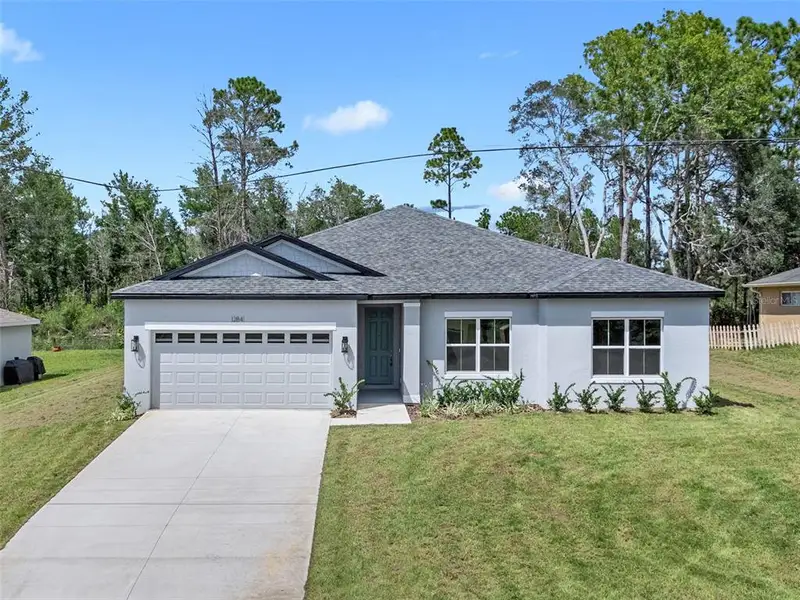Front exterior of a new home in , Ocala, FL, highlighting curb appeal (Image 1).