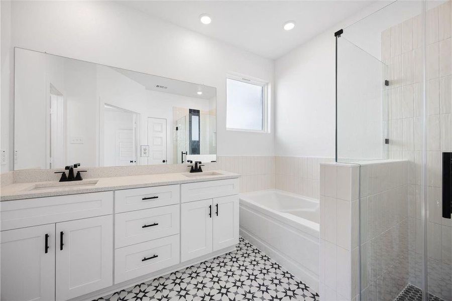 This bathroom features a modern design with a double vanity, sleek black fixtures, a large mirror, and stylish patterned tile flooring. It includes a spacious bathtub and a separate glass-enclosed shower, offering both comfort and functionality. This bathroom features a modern design with a double vanity, sleek black fixtures, a large mirror, and stylish patterned tile flooring. It includes a spacious bathtub and a separate glass-enclosed shower, offering both comfort and functionality.