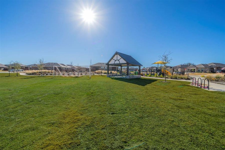 View of property's community featuring a gazebo, a yard, and a playground