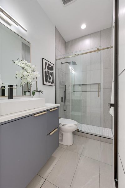 Bathroom with vanity, a shower stall, light tile patterned floors, and recessed lighting