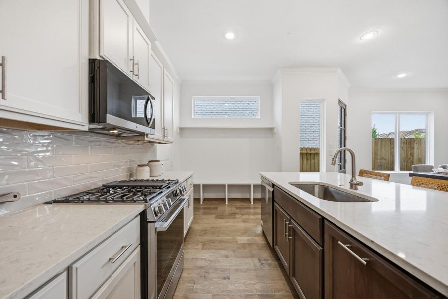 Sophistication Redefined: The kitchen's centerpiece—an elegant island—awaits the glow of your chosen pendant light upgrade, making every moment in the heart of the home shine brighter.