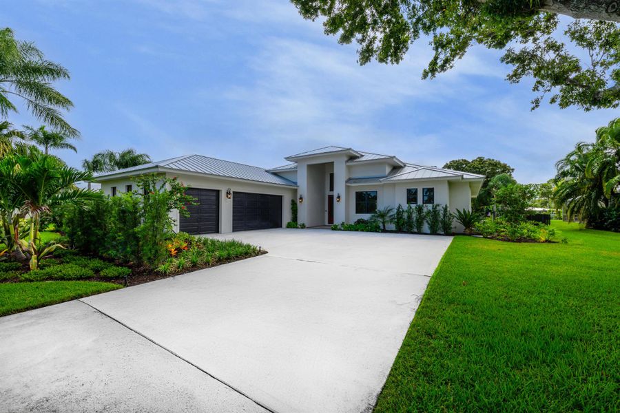 Front exterior of a new home in , Stuart, FL, highlighting curb appeal (Image 1).