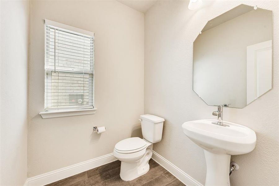 Bathroom featuring baseboards and dark wood-type flooring