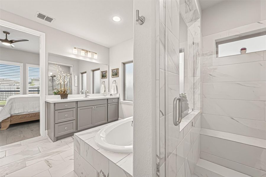 Beautiful walk-in shower featuring a built-in bench. (Note: Photo is staged; property is currently vacant.). Beautiful walk-in shower featuring a built-in bench. (Note: Photo is staged; property is currently vacant.).