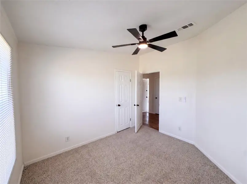 Plush carpeting and neutral walls define this versatile private bedroom space.
