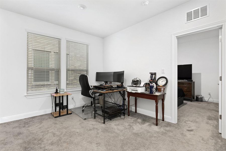 Office featuring light colored carpet and baseboards