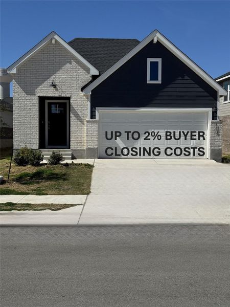View of front of house with concrete driveway, brick siding, and a garage