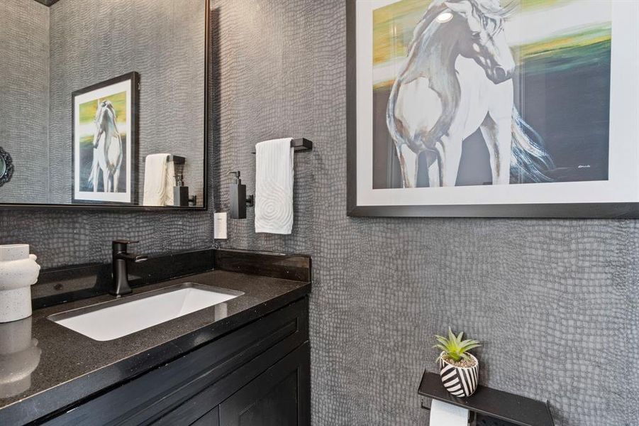 The half bathroom is located down a hall from the living space. This bathroom is finished with an exquisite design.