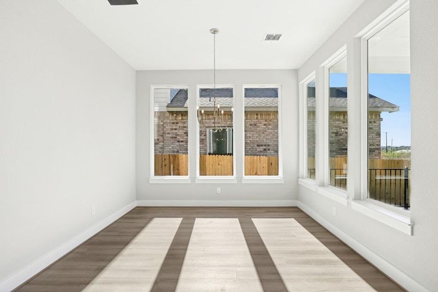 Unfurnished sunroom with baseboards and wood finished floors Unfurnished sunroom with baseboards and wood finished floors