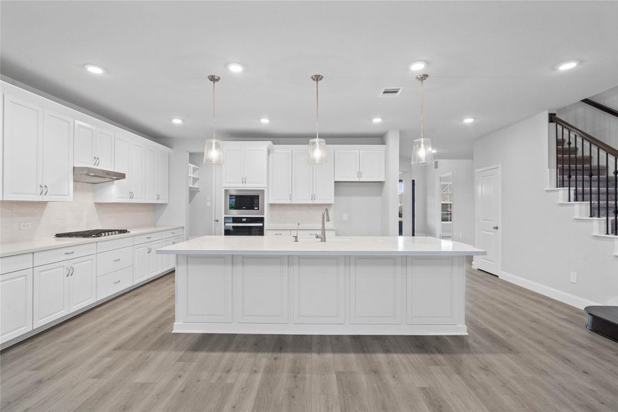 Grand view of this stunning gourmet kitchen serves as the true heart of the home. Its open-concept layout seamlessly connects to the living spaces for effortless entertaining. Grand view of this stunning gourmet kitchen serves as the true heart of the home. Its open-concept layout seamlessly connects to the living spaces for effortless entertaining.