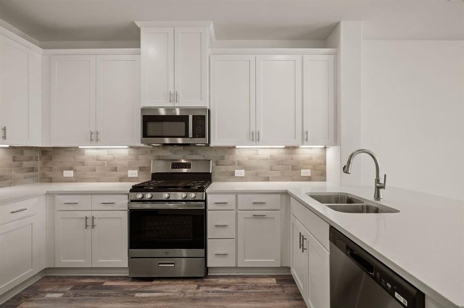 Featuring fantastic storage and prep space, this dream kitchen is finished in a classic color palette that will always be in style!