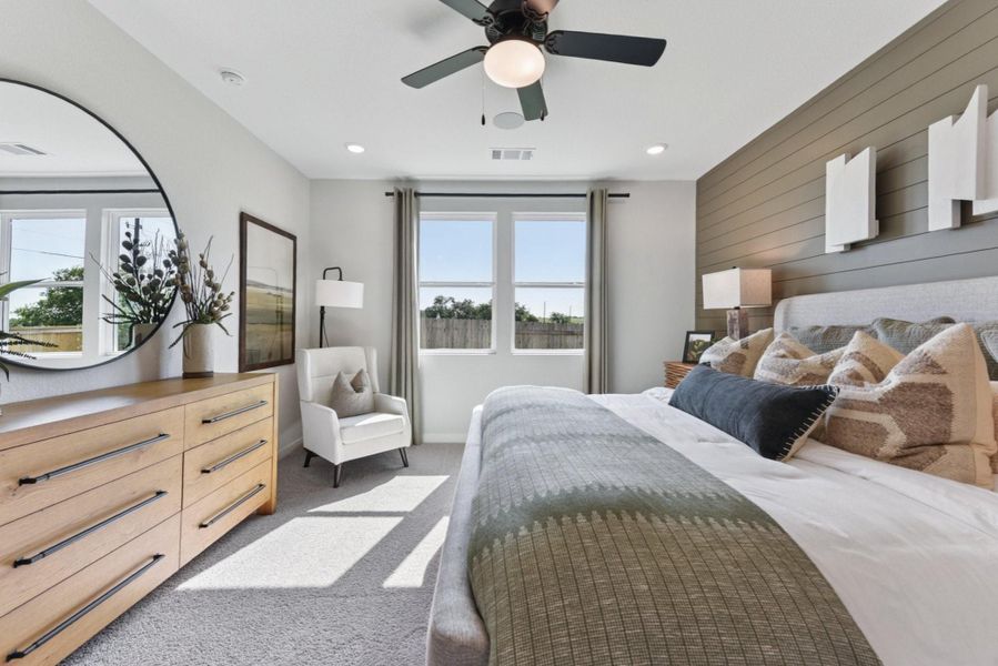 Bedroom with wood walls, light carpet, a ceiling fan, and recessed lighting