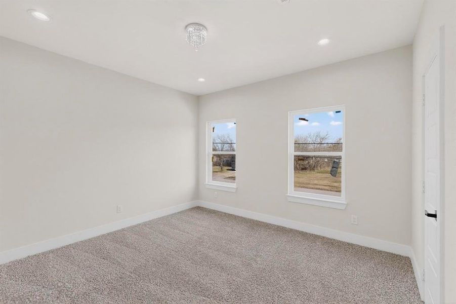 Empty room featuring light carpet and recessed lighting Empty room featuring light carpet and recessed lighting