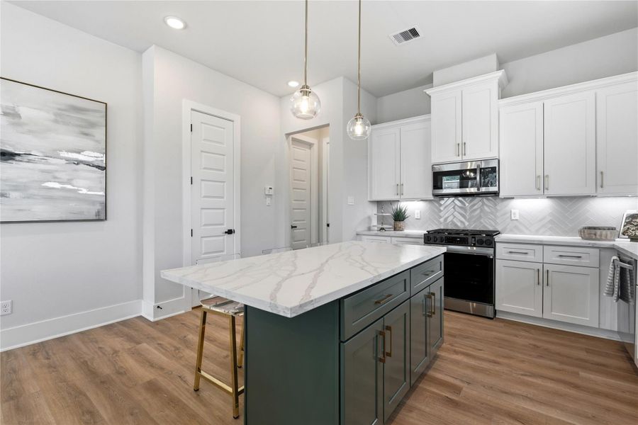 A statement island anchors the kitchen, combining contrasting cabinetry with ample workspace for both everyday use and casual gathering. A statement island anchors the kitchen, combining contrasting cabinetry with ample workspace for both everyday use and casual gathering.