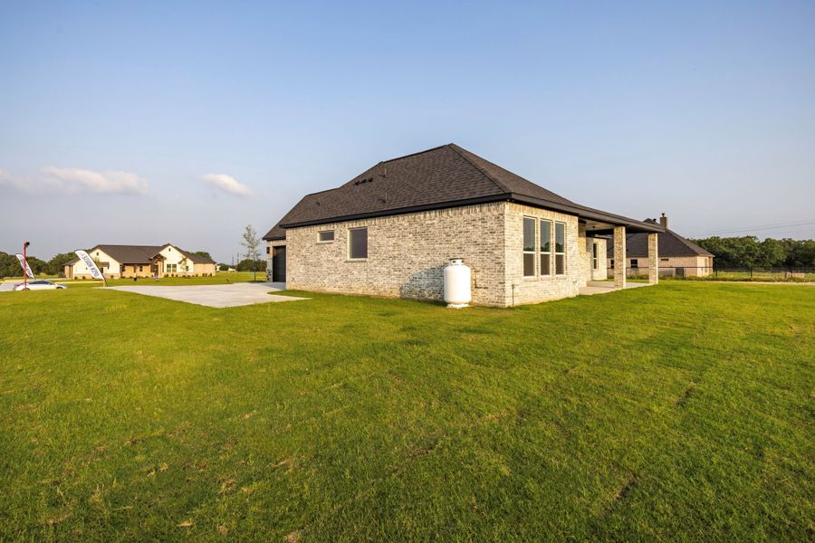 Front exterior of a new home in Prairie Winds Estates, Poolville, TX, highlighting curb appeal (Image 7). Front exterior of a new home in Prairie Winds Estates, Poolville, TX, highlighting curb appeal (Image 7).