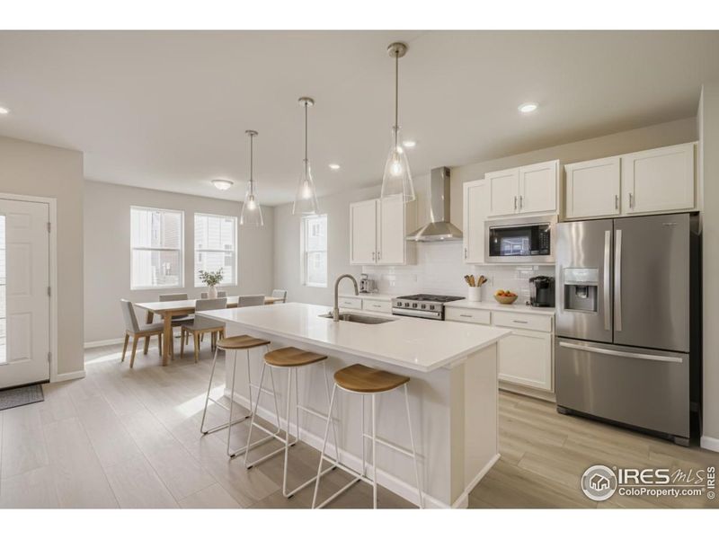 White soft-close cabnetry, slide-in gas range and separate dining area