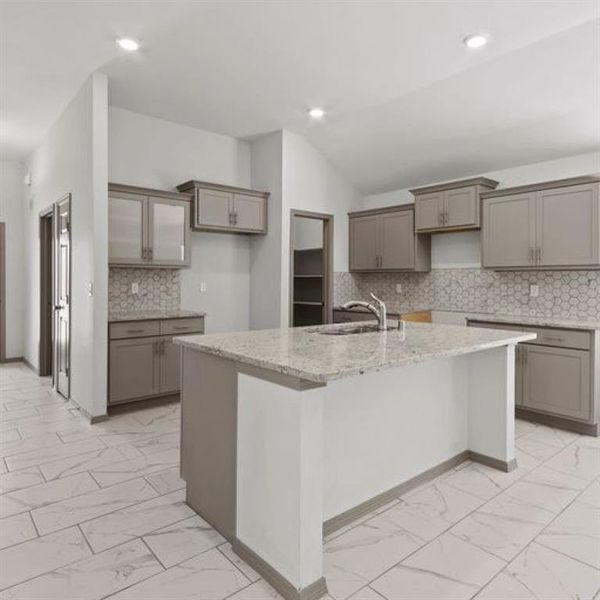 A perfectly situated breakfast bar compliments the center island in this open plan kitchen. **This image is from another Saratoga Home with similar floor plan - Myrtle Floorplan.**