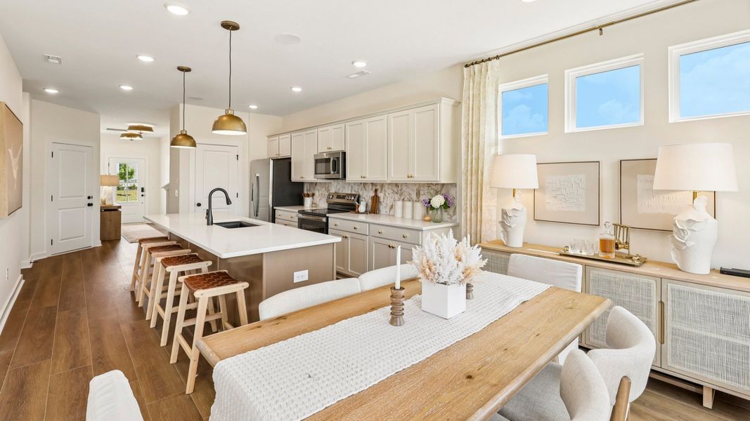 Kitchen with tile backsplash, pendant lighting, and quartz countertops Kitchen with tile backsplash, pendant lighting, and quartz countertops