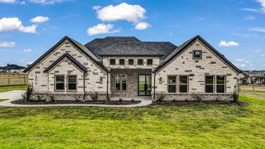 View of front of house with brick siding and stone siding