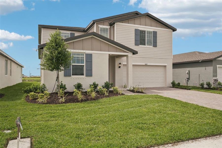 Front exterior of a new home in Oakfield Trails - Classic Series, Parrish, FL, highlighting curb appeal (Image 2). Front exterior of a new home in Oakfield Trails - Classic Series, Parrish, FL, highlighting curb appeal (Image 2).