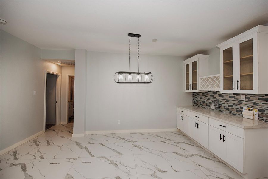 Incredible formal dining area with custom lighting and a wall unit to serve as a buffet when entertaining. Incredible formal dining area with custom lighting and a wall unit to serve as a buffet when entertaining.