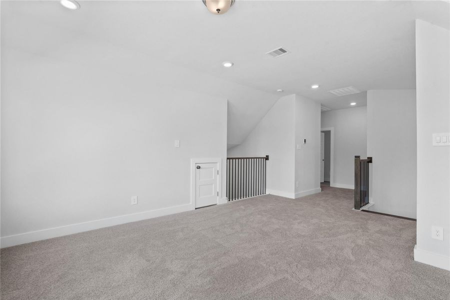 Additional view rom Game Room to staircase and hallway leading to the secondary bedrooms and bathroom.