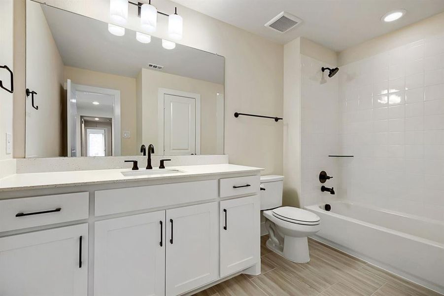 Full bathroom featuring vanity, recessed lighting, and bathtub / shower combination Full bathroom featuring vanity, recessed lighting, and bathtub / shower combination