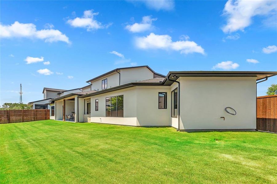 Rear view of house featuring stucco siding Rear view of house featuring stucco siding