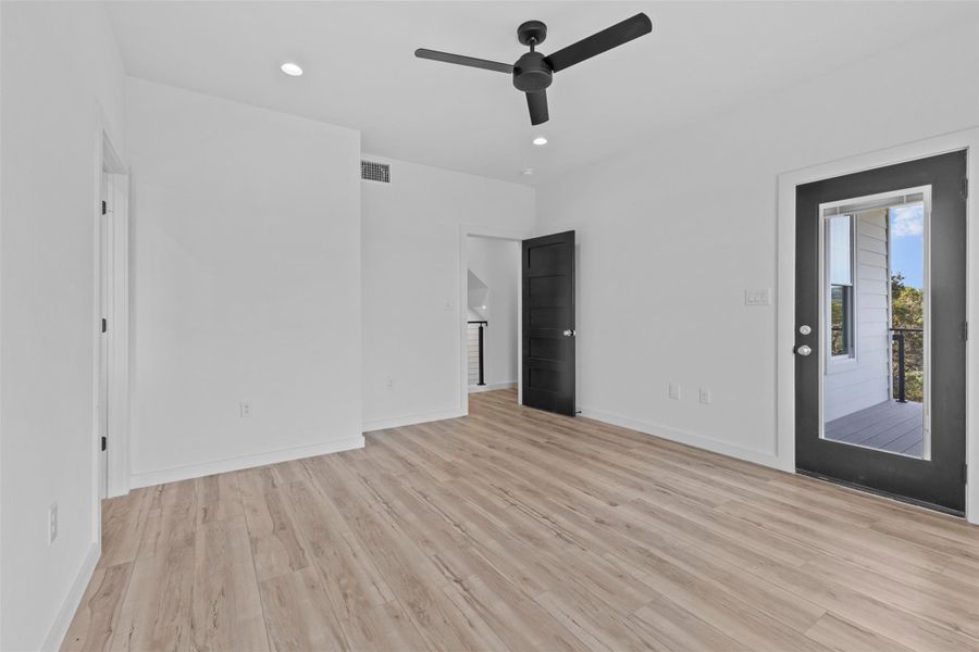 Unfurnished bedroom featuring access to exterior, light wood finished floors, a ceiling fan, and recessed lighting