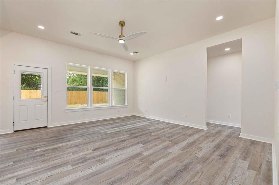 Empty room with recessed lighting, light wood-type flooring, and a ceiling fan Empty room with recessed lighting, light wood-type flooring, and a ceiling fan