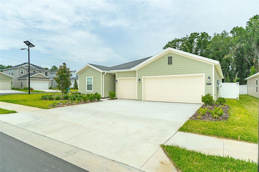 Front exterior of a new home in Pioneer Ranch, Ocala, FL, highlighting curb appeal (Image 1). Front exterior of a new home in Pioneer Ranch, Ocala, FL, highlighting curb appeal (Image 1).