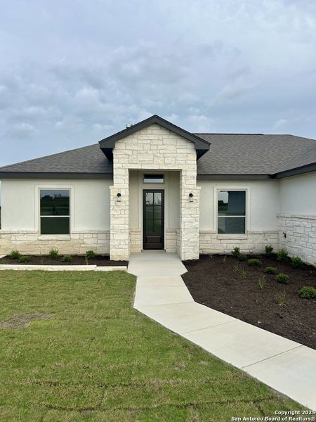 Front exterior of a new home in , La Vernia, TX, highlighting curb appeal (Image 30). Front exterior of a new home in , La Vernia, TX, highlighting curb appeal (Image 30).