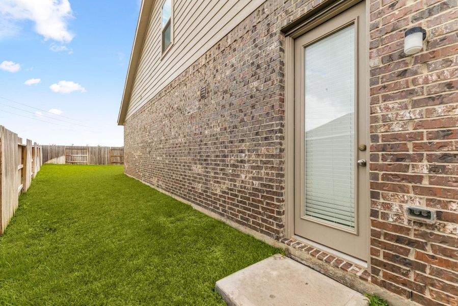 Exterior details and patio area of a home in Sunterra, Katy (Image 3).
