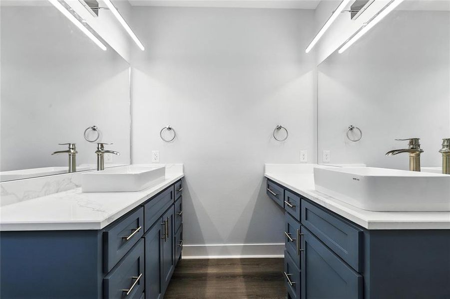 Full bath with vanity and wood finished floors