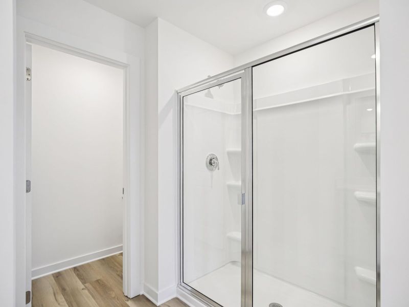 The primary bathroom offers dual vanity sinks and a walk-in shower.