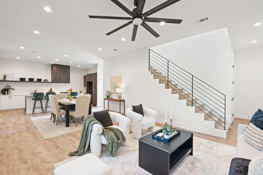 Living room featuring recessed lighting, light wood-style floors, stairway, and a ceiling fan