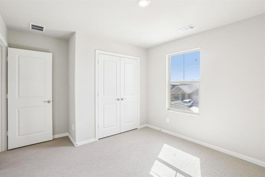 Unfurnished bedroom with carpet flooring, a closet, and recessed lighting Unfurnished bedroom with carpet flooring, a closet, and recessed lighting
